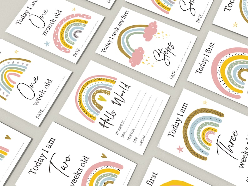 May include: A set of ten rainbow-themed baby milestone cards with colourful rainbows and stars. The cards feature phrases like "Today I am One Week Old" and "Today I Took My First Steps".