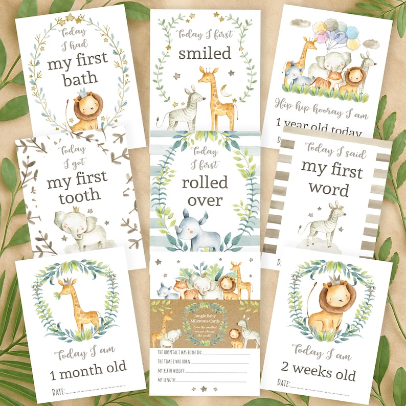 May include: A set of ten baby milestone cards featuring jungle animal illustrations. The cards are white with green and gold accents. The cards include phrases like "Today I had my first bath", "Today I first smiled", "Today I got my first tooth", "Today I first rolled over", "Hip hip hooray I am 1 year old today", "Today I said my first word", "Today I am 1 month old", and "Today I am 2 weeks old".