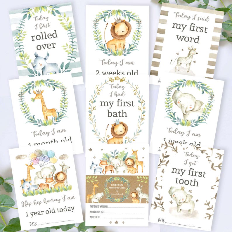 May include: A set of ten illustrated milestone cards for a baby featuring jungle animals. The cards are decorated with green leaves and feature phrases like "Today I am 1 month old" and "Today I had my first bath".