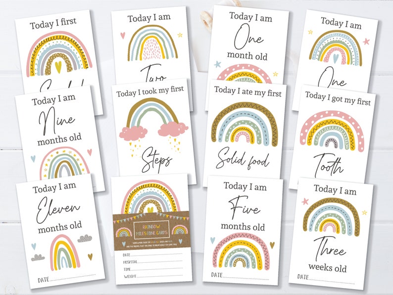 May include: Set of ten rainbow milestone cards for a baby. Each card features a rainbow with different colours and patterns, and a milestone message. The messages include "Today I am One month old", "Today I am Nine months old", "Today I am Eleven months old", "Today I am Three weeks old", "Today I am Five months old", "Today I am One", "Today I got my first Tooth", "Today I ate my first Solid food", "Today I took my first Steps", and "Today I first".