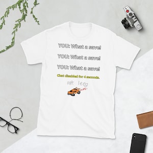 May include: White t-shirt with the text "YOU: What a save!" repeated three times. Below the text is a drawing of an orange race car with the text "roxt leeg" and "Chat disabled for 4 seconds."