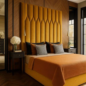 Puede incluir: Un dormitorio lujoso con una cama tapizada de color amarillo mostaza y un cabecero a juego. La cama está adornada con almohadas negras y estampadas y una manta naranja. Los paneles y el suelo de madera oscura complementan la cálida combinación de colores. Lámparas colgantes decorativas sobre las mesitas de noche.