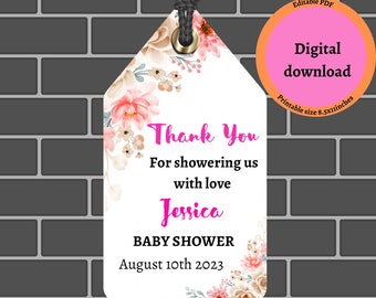 May include: A printable thank you tag for a baby shower. The tag features a floral design with pink and beige flowers. The text on the tag reads "Thank You for showering us with love Jessica Baby Shower August 10th 2023".