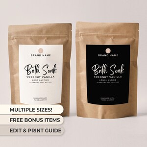 Puede incluir: Dos bolsas de papel marrón de baño de inmersión con etiquetas. Una etiqueta es blanca, la otra negra. Ambas dicen "Bath Soak Coconut Vanilla" y "Hydrating Shea Butter". El texto "Multiple Sizes!" es visible.