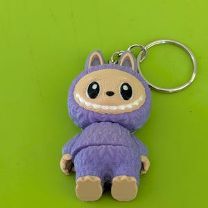 Flexi Labubu Keychain – Cute Art Toy-Inspired Figure, Purple Bunny Suit, 3D Printed Collectible Gift for Toy & Keychain Lovers