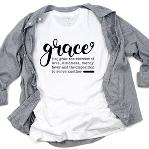 May include: White t-shirt with the word "grace" in black cursive lettering and a definition of the word below it. The definition reads: "(m) gr&aring;s: the exercise of love, kindness, mercy, favor and the disposition to serve another"