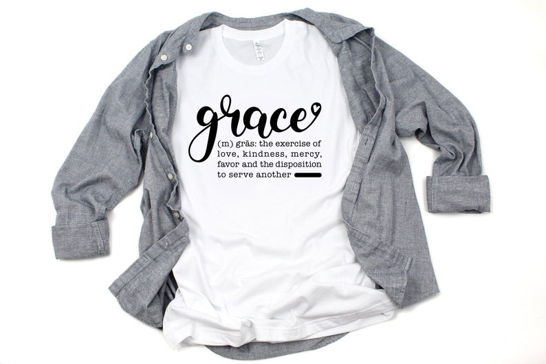 May include: White t-shirt with the word "grace" in black cursive lettering and a definition of the word below it. The definition reads: "(m) gr&aring;s: the exercise of love, kindness, mercy, favor and the disposition to serve another"