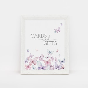 May include: White frame with a sign that says "CARDS and GIFTS" in black text. The sign is decorated with watercolor butterflies in shades of pink, purple, and blue.