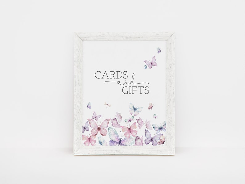 May include: White frame with a sign that says "CARDS and GIFTS" in black text. The sign is decorated with watercolor butterflies in shades of pink, purple, and blue.