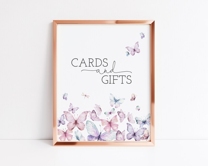 May include: A printable sign with a rose gold frame and the text "CARDS and GIFTS" in black. The background is white with a watercolor design of butterflies in shades of pink, purple, and blue.