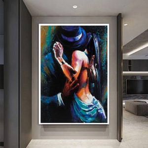 May include: A painting of a couple dancing, the man in a dark suit and hat, the woman in a blue and purple dress. The painting is done in a colorful, abstract style.