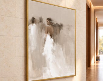 May include: A large square canvas painting in a gold frame featuring an abstract impressionist depiction of a person in a white dress. The artwork uses a neutral color palette of beige, cream, and white tones with soft, blended brushstrokes.