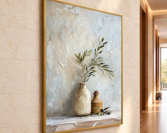 May include: A framed wall art piece featuring an oil painting of two ceramic vessels on a ledge. One tall, light-colored vase holds olive branches, while a smaller, darker brown bottle sits beside it with a few loose olives on the surface.