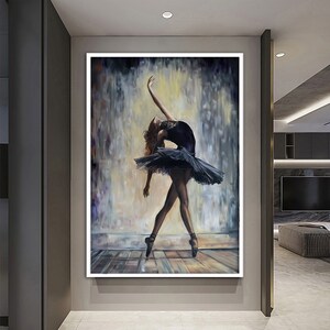 May include: A painting of a ballerina in a black tutu and pointe shoes, performing a graceful pose against a blurred background of soft colors.