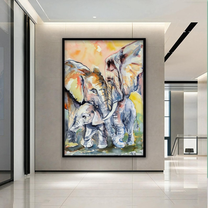 May include: A watercolor painting of three elephants, two adults and a baby, standing close together. The elephants are painted in shades of gray, brown, and white, with a yellow and orange background.