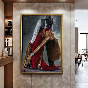 May include: A painting of a couple dancing. The man is wearing a black hat and a white shirt. The woman is wearing a red dress. The painting is set against a dark background.