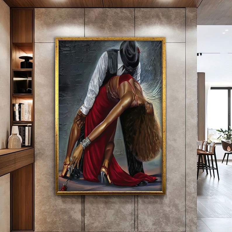 May include: A painting of a couple dancing. The man is wearing a black hat and a white shirt. The woman is wearing a red dress. The painting is set against a dark background.