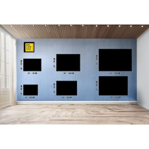 May include: A wall with different sized black canvas prints, with measurements in centimeters, for sale. The text "BIG CANVAS" is in a yellow box on the wall.