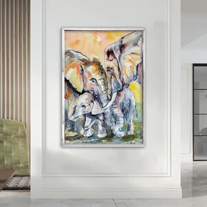 May include: Watercolor painting of three elephants, two adults and a baby, standing close together. The elephants are painted in shades of gray, brown, and white, with a soft, watercolor background.