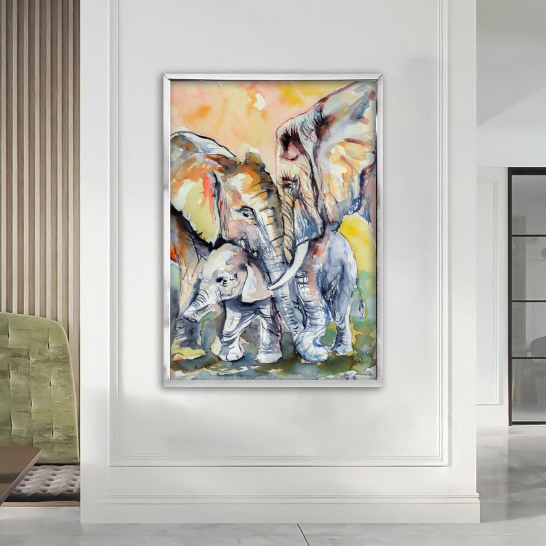 May include: Watercolor painting of three elephants, two adults and a baby, standing close together. The elephants are painted in shades of gray, brown, and white, with a soft, watercolor background.