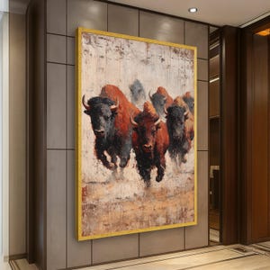 May include: An oil painting of a herd of bison running across a textured, off-white background. The bison are depicted in shades of red, brown, and black, with a golden frame. The artwork is displayed on a neutral-toned wall.