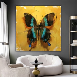 May include: A painting of a blue and black butterfly on a yellow background. The butterfly is painted in a realistic style with visible brushstrokes.
