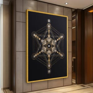 May include: A framed wall art piece featuring a geometric design in gold and silver against a black background. The artwork has a gold frame and is displayed in a modern interior setting.