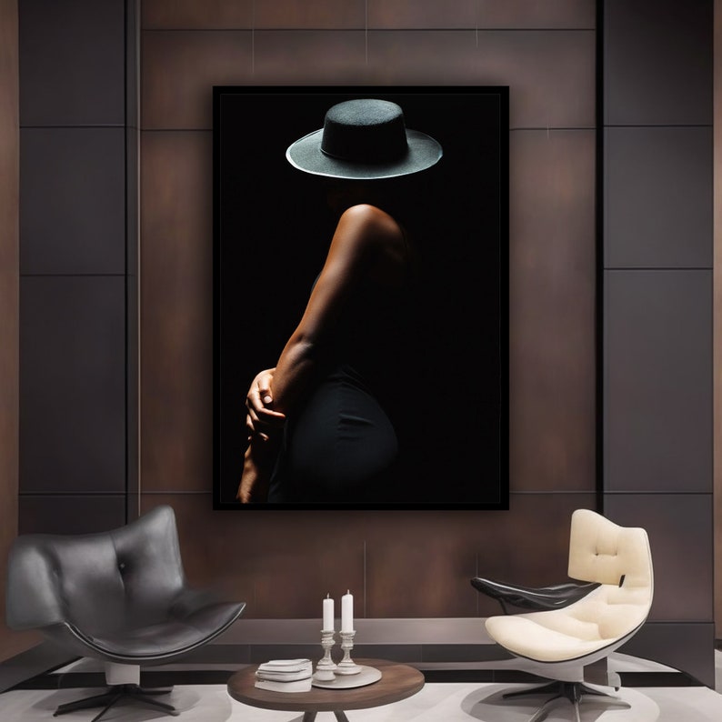 May include: A black and white photo of a person wearing a black hat and a black dress. The person is standing in a dark room and the light is coming from the left side of the image.