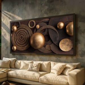 May include: A large, rectangular wall art piece featuring a dark wooden frame. The artwork showcases a layered design of wooden circles, rings, and spheres in varying sizes and shades of brown and gold. The piece is mounted above a beige sectional sofa.