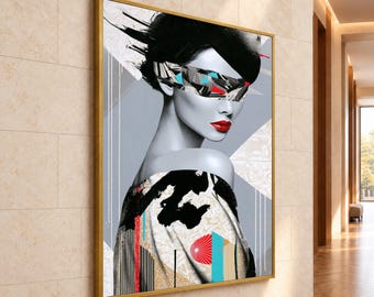May include: A rectangular framed wall art piece featuring a grayscale portrait of a person with a black hat and a geometric, multicolored blindfold. The subject has bright red lips and wears a patterned garment with black, white, and blue accents.