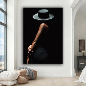 May include: A silhouette of a person wearing a black hat against a dark background.
