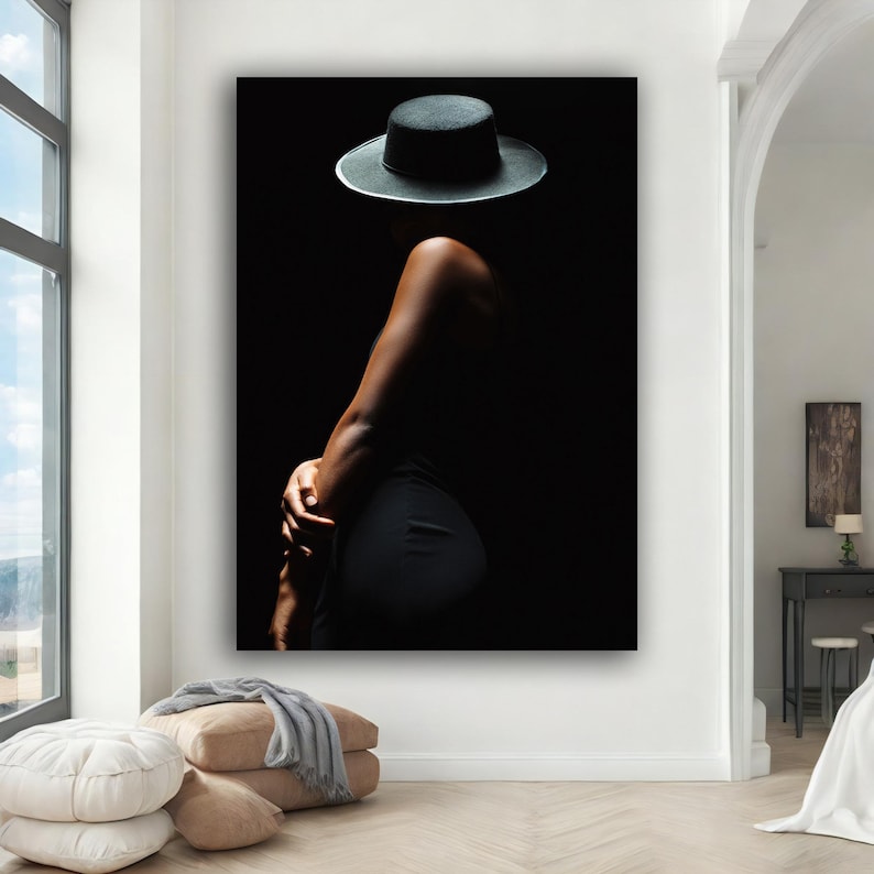 May include: A silhouette of a person wearing a black hat against a dark background.