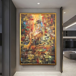 May include: A colorful abstract painting of a meditating Buddha figure in a gold frame. The painting features a mix of warm and cool colors, including shades of yellow, orange, red, blue, and green. The Buddha is depicted in a seated position with hands in a mudra gesture, surrounded by lotus flowers and other abstract elements.