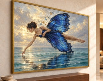 May include: A rectangular wall art print in a gold frame depicting a figure with large, vibrant blue butterfly wings hovering over a calm ocean. The figure reaches down to touch the water surface under a cloudy, golden sunset sky with small butterflies.