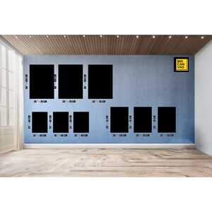 May include: A wall with a variety of black canvas prints in different sizes. The prints are arranged in a grid pattern. The largest print is 40 by 100 centimeters, and the smallest print is 16 by 40 centimeters. The prints are all black and white, and they are all framed in black.