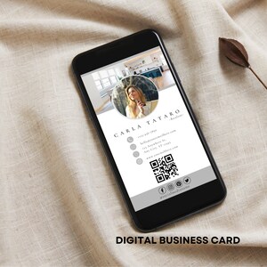 May include: A digital business card with a gray and white design. The card features a photo of a woman, her name, contact information, and a QR code. The text on the card reads "CARLA TATARO - Realtor" and includes a phone number, email address, street address, city, state, zip code, website address, and social media handles.