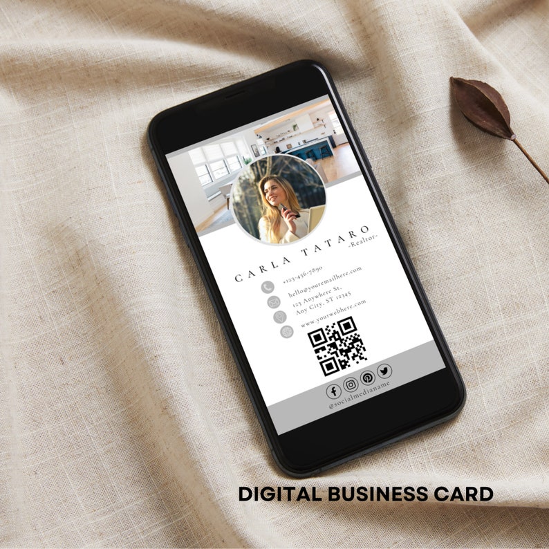 May include: A digital business card with a gray and white design. The card features a photo of a woman, her name, contact information, and a QR code. The text on the card reads "CARLA TATARO - Realtor" and includes a phone number, email address, street address, city, state, zip code, website address, and social media handles.