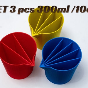 May include: Set of three 300ml/10oz measuring cups in red, yellow, and blue. Each cup has five sections for measuring ingredients.
