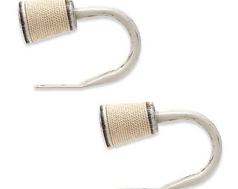 May include: Two white metal curtain hooks with a rope-wrapped finial. The hooks are designed to hold curtains or drapes.