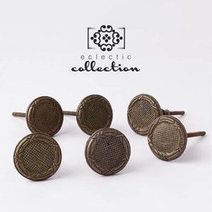 May include: Six antique-style bronze cabinet knobs with a decorative woven pattern. The knobs have a screw on the back for attaching to furniture.