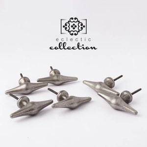 May include: Five silver-toned metal cabinet knobs with a diamond-shaped design. The knobs have a rustic, vintage look.