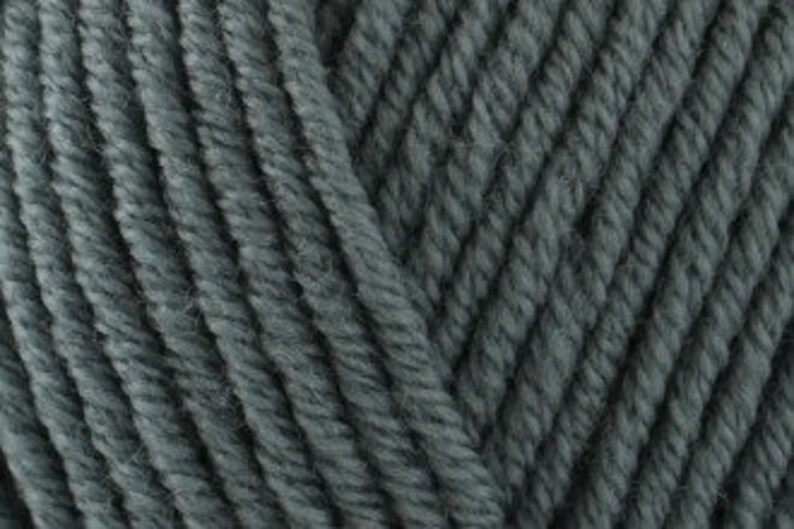 May include: A close-up view of dark charcoal gray yarn featuring a multi-ply twisted construction. The fibers are arranged in parallel diagonal lines, showcasing the texture and consistent thickness of the individual strands of the spun material.