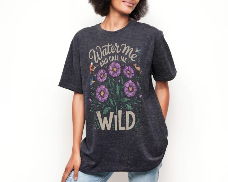 May include: A dark gray t-shirt with a floral design and the text "Water Me and Call Me Wild".