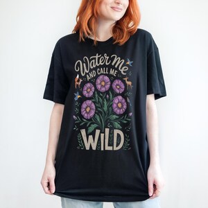 May include: Black t-shirt with a floral design and the text "Water me and call me wild".