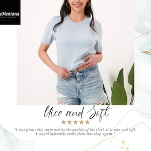 May include: A light blue t-shirt with a crew neck and short sleeves. The shirt is made of a soft, comfortable fabric. "Nice and Soft" is written in cursive above five stars. The text below the stars reads: "I was pleasantly surprised by the quality of the shirt, it is nice and soft. I would definitely order from this shop again."
