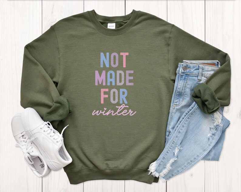 May include: A green sweatshirt with the text "NOT MADE FOR winter" in colorful letters.