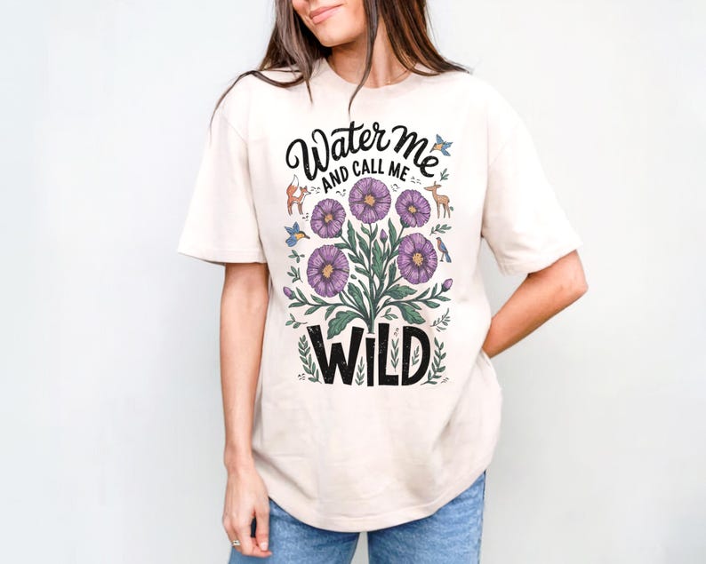 May include: A cream colored t-shirt with a floral design and the text "Water Me And Call Me Wild".