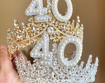 May include: A gold and silver jeweled crown with two white pearl-encrusted numbers, "40", on top.