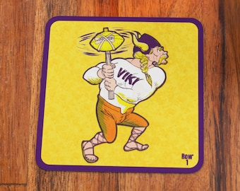 May include: A purple and yellow square coaster with a cartoon Viking holding a football helmet. The Viking is wearing a white shirt with the word "VIKI" on it. The text "ROW 1" is in the bottom right corner.
