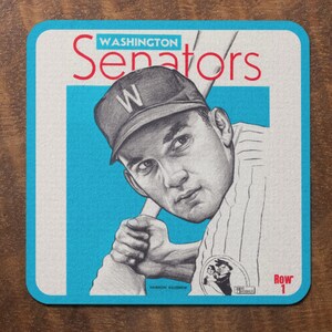 May include: A vintage-style baseball card featuring a black and white illustration of a baseball player wearing a Washington Senators uniform and a baseball cap with a "W" on it. The card has a blue background with the text "WASHINGTON Senators" in red and white. The card also has the text "Row 1" in red.